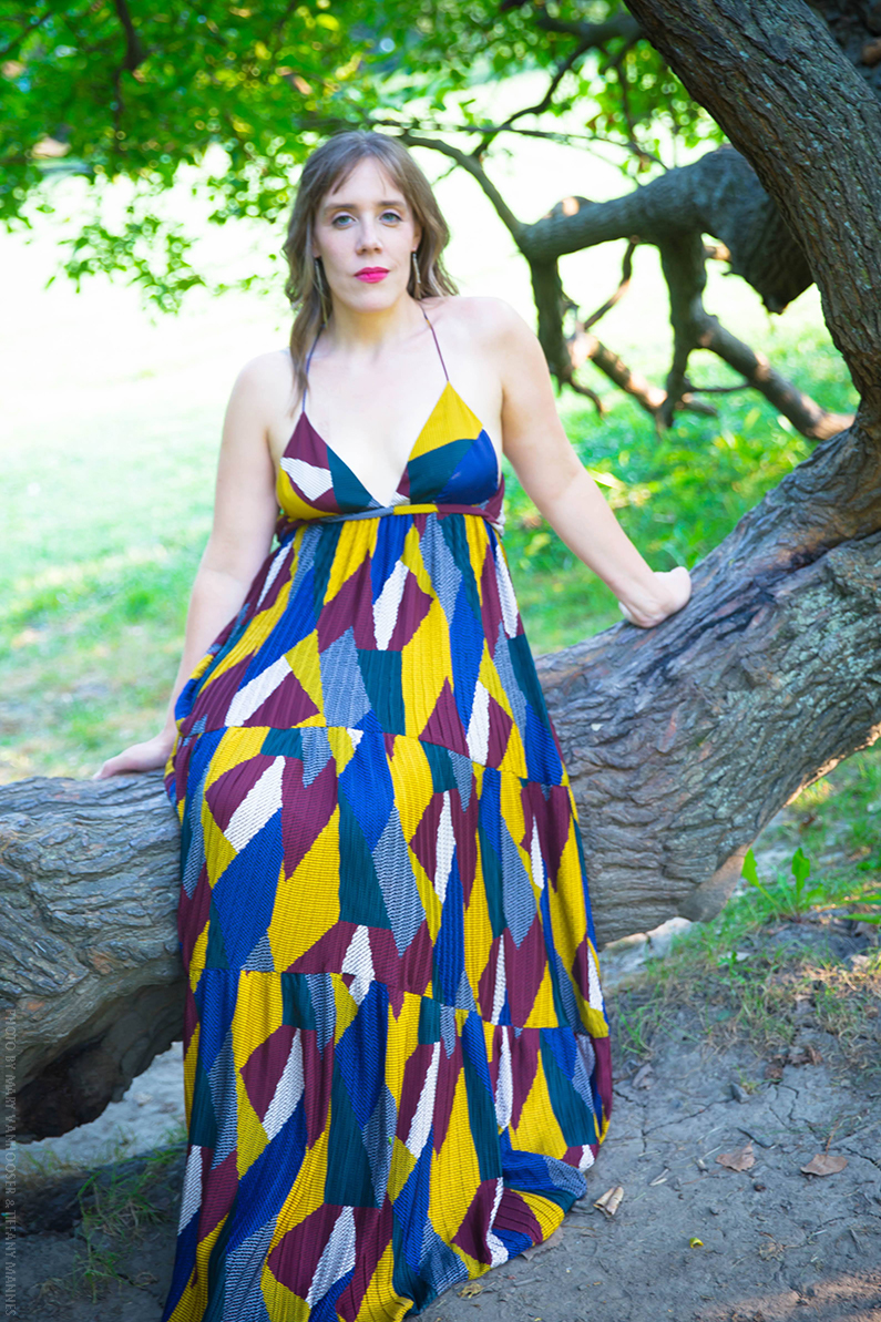 Color full-length photo of LV Wood in outdoor industrial lot with shippping containers in the distant background